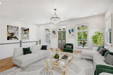 Living room featuring plenty of natural light, har