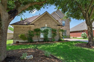 Traditional-style house with brick siding, a fron