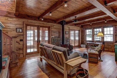 Open main level floor plan with beamed ceilings, douglas fir wood floors & basswood paneling.