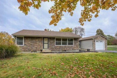 Ranch style home has vinyl siding with stone on th