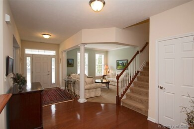 Foyer to Living Room ~ Columns, transom window, be