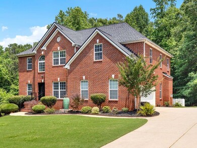 View of front of property featuring concrete driveway, brick siding, an attached garage, a front lawn, and a shingled roof