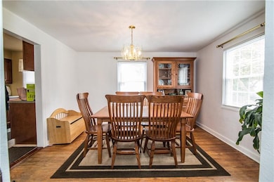 The dining room has hard wood floors and the windo