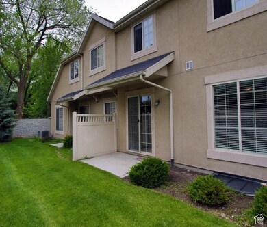 Back of house with a patio and stucco siding