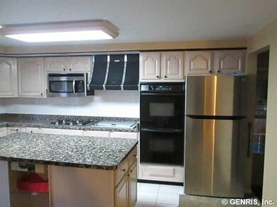 Kitchen. New stainless refrigerator, granite look 