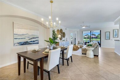 Dining room with ornamental molding, light tile patterned floors, a chandelier, ceiling fan, and baseboards