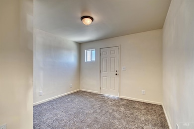 Carpeted spare room with baseboards