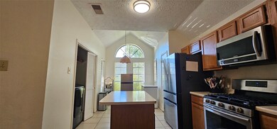 The kitchen has a laundry area adjacent to it. The