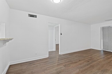 Living area with brand new flooring and paint.   The living room opens up to a huge deck.