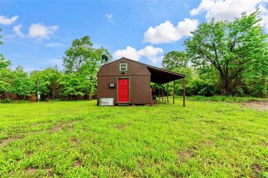 View of shed / structure with a lawn