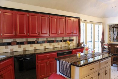 Kitchen w/ center island, granite countertops.