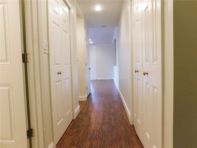 Long hallway to living area with tons of storage o