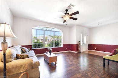 Living area with wood finished floors, ceiling fan, and baseboards