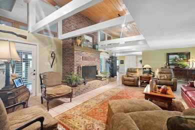 Tiled living room with brick wall, a fireplace, lo