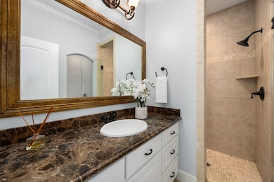 The ensuite bath features a large vanity and overs