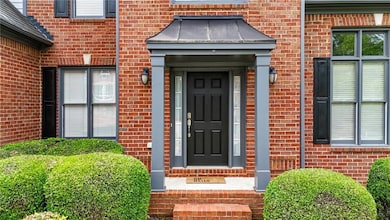 Doorway to property with brick siding