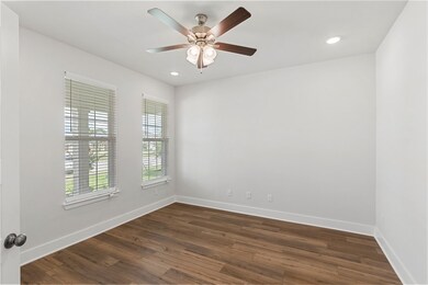 Unfurnished room featuring dark wood-type flooring