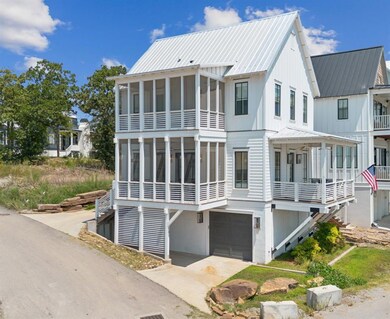 Back of property featuring a covered patio, metal 