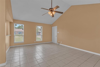 Empty room with ceiling fan, light tile patterned