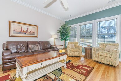 Living room featuring ornamental molding, light ha