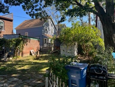 View of property exterior featuring a lawn