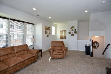 The living room is further enhanced by overhead li