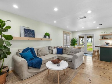 The living room is open to the dining room and kitchen.