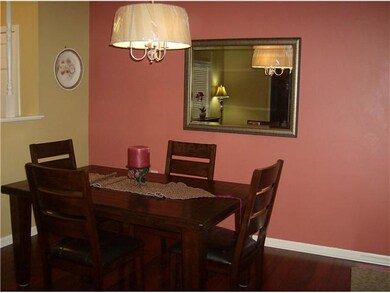 Elegant formal dining with hardwood floors and cha