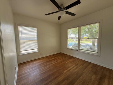 Empty room featuring wood finished floors, basebo