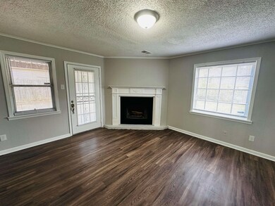 Unfurnished living room with dark wood-style floor