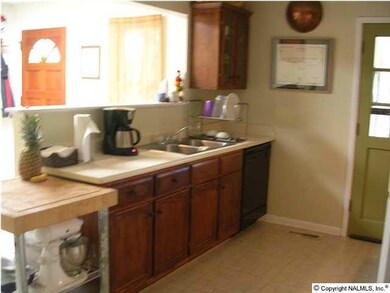 Second view of large kitchen featuring eat in area and loads of cabinets