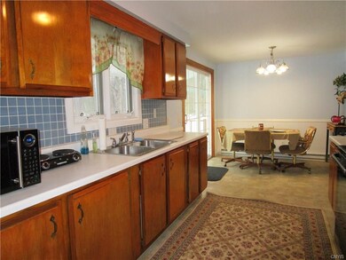 Eat-in kitchen with tile backsplash.