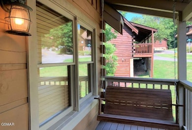 Karens cabin front porch swing
