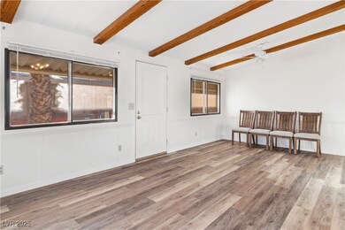 Living room with vaulted ceiling with beams, ceili