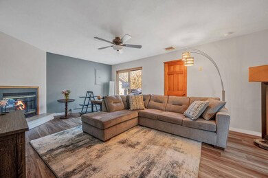 Living room featuring a glass covered fireplace, l