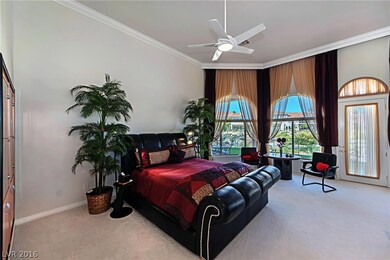 The romantic master bedroom has crown molding, a f