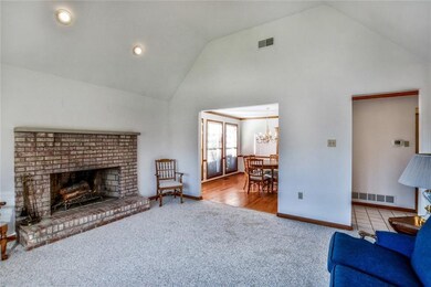 Living room with fireplace and vaulted ceilings.