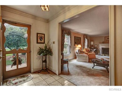 Spacious  foyer has a coat closet, molding, chande