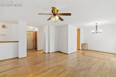 Empty room featuring light wood-style floors, a ch