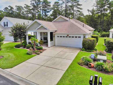 Large, concrete driveway. Mature landscaping beds 