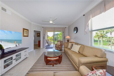 Living room with ceiling fan, visible vents, crown