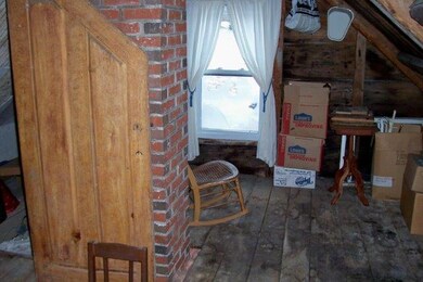 Attic with vinyl replacement window.