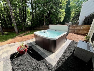 View of swimming pool with a hot tub and a fenced 