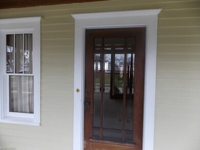 Front door with leaded glass opens into living roo