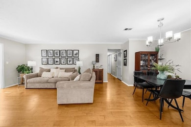 Living room featuring ornamental molding, a notabl