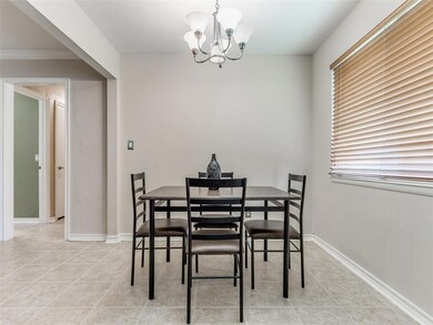 Dining area featuring crown molding, a chandelier,
