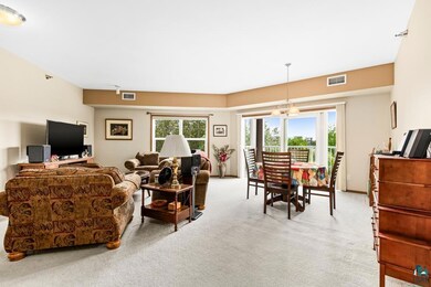 Living room with carpet flooring and a chandelier