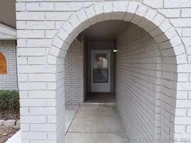 New concrete front porch with decorative brick arc