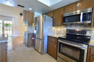 Travertine stone floors, stainless steel appliance