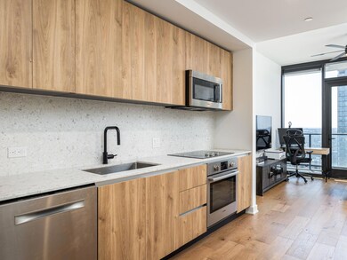Kitchen featuring a wall of windows, a sink, stai